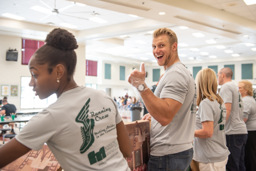 Man gives enthusiastic thumbs up while serving lunch to DeLand High School teachers