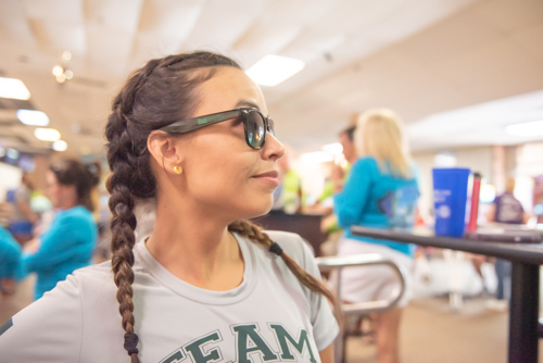A woman shows off her Mainstreet Community Bank sunglasses at bowling alley